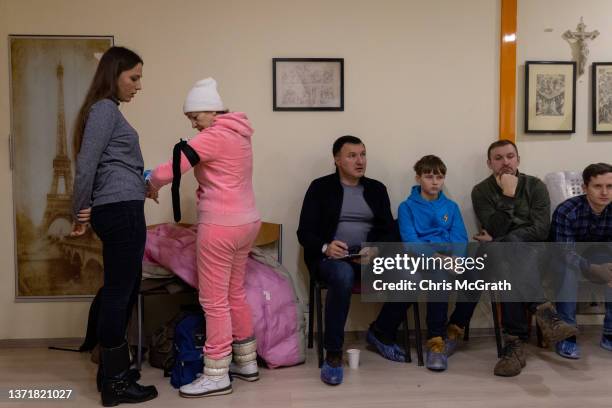 Women practice how to use a tourniquet during a medical training session held by "The Brotherhood", a Christian Territorial Defense unit on February...