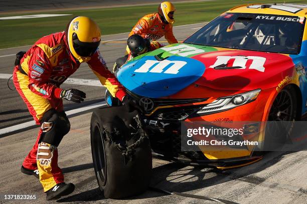 The pit crew remove a damaged tire on the M&M's Toyota, driven by Kyle Busch during the NASCAR Cup Series 64th Annual Daytona 500 at Daytona...