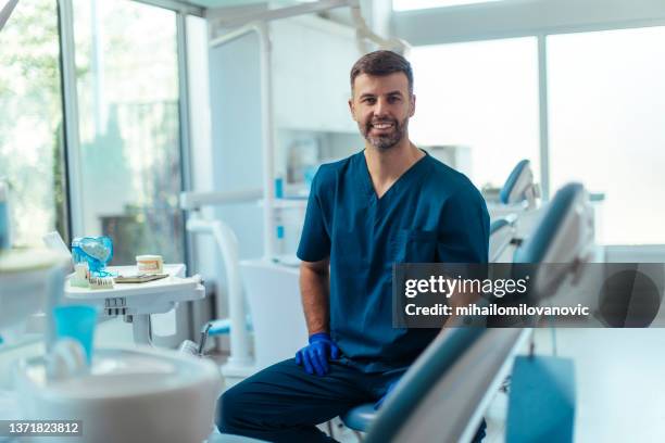 he loves making his clients happy - male dentist stock pictures, royalty-free photos & images