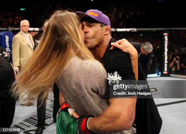Joana Prado kisses her husband Vitor Belfort after he defeated Anthony Johnson in a middleweight bout during UFC 142 at HSBC Arena on January 14,...
