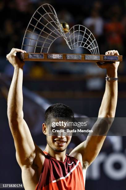 Carlos Alcaraz of Spain celebrates with the trophy after defeating Diego Schwartzman of Argentina after the men's singles final match of the ATP Rio...