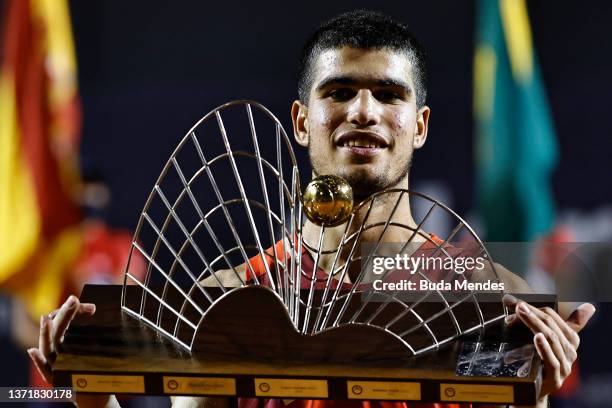Carlos Alcaraz of Spain celebrates with the trophy after defeating Diego Schwartzman of Argentina after the men's singles final match of the ATP Rio...