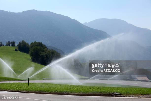 Swirl of irrigation in a road of Alto Adige. Sudtirol. Italy. Europe.