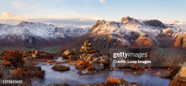 Snow capped mountains of the Langdales at sunset viewed from Lingmoor Fell.