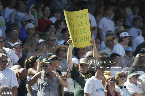 Fan of the Oakland Athletics holds up a sign declaring the team invincible during the MLB game against the Kansas City Royals at the Network...