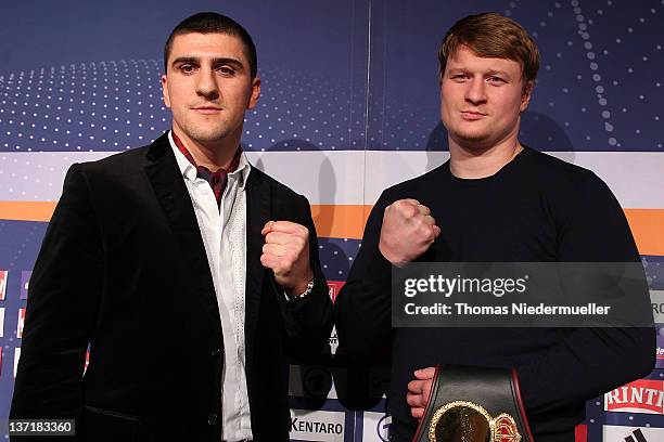 Marco Huck of Germany and Alexander Povetkin of Russia pose after a press conference at the Porsche Arena on January 16, 2012 in Stuttgart, Germany....