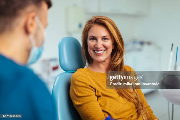 showing off the smile - smiling dentist stock pictures, royalty-free photos & images