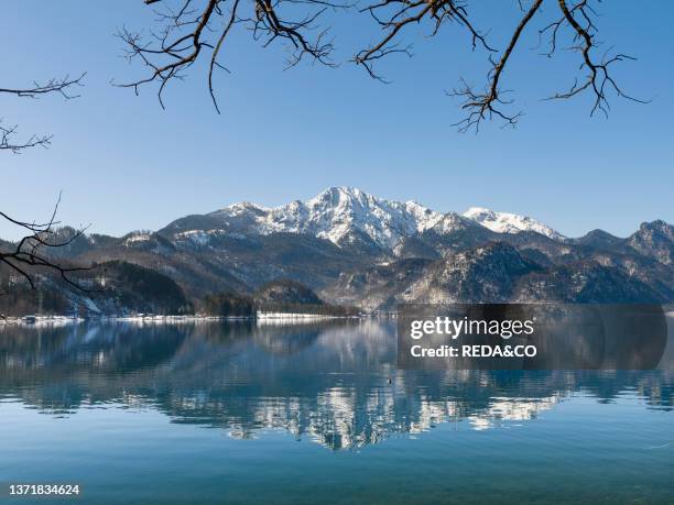 Lake Kochelsee at village Kochel am See during winter in the bavarian Alps. Mt. Herzogstand in the background. Europe. Germany. Bavaria.