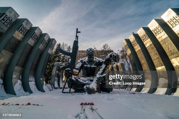 Roses grace the freshly fallen snow in front of the Afghanistan War Memorial known as the Black Tulip in downtown Ekaterinburg in Russia.