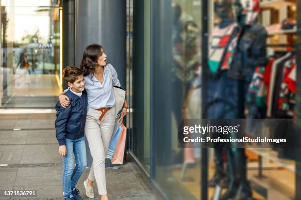 a young mother and son are enjoying a day together in relaxing day for shopping. - teenager boy shopping bildbanksfoton och bilder