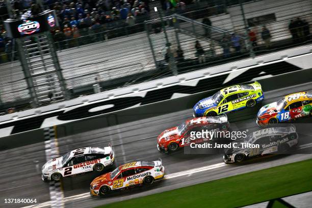 Austin Cindric, driver of the Discount Tire Ford, crosses the finish line to win the NASCAR Cup Series 64th Annual Daytona 500 at Daytona...