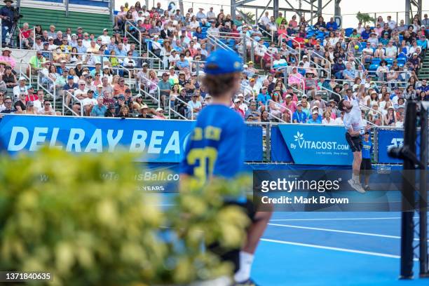 Cameron Norrie of Great Britain serves to Reilly Opelka of the United States in second set tiebreaker during the Finals of the Delray Beach Open by...