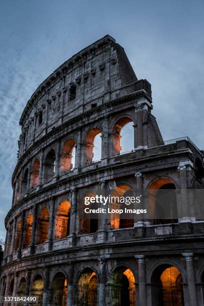 Detail of the Colosseum of Rome illuminated in the waning evening light.