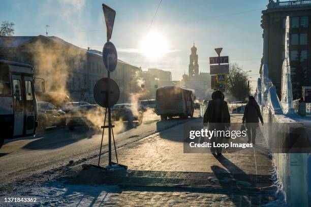 Exhaust catches the light of sunrise in the early morning chill of Ekaterinburg in Russia.