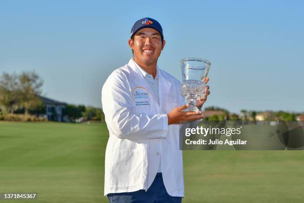Byeong Hun An of South Korea poses with the trophy after winning the 2022 LECOM Suncoast Classic at Lakewood National Golf Club Commander on February...