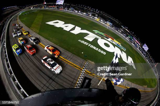 Austin Cindric, driver of the Discount Tire Ford, takes the checkered flag to win the NASCAR Cup Series 64th Annual Daytona 500 at Daytona...