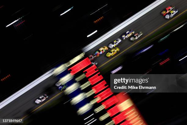 Austin Cindric, driver of the Discount Tire Ford, leads the field during the NASCAR Cup Series 64th Annual Daytona 500 at Daytona International...