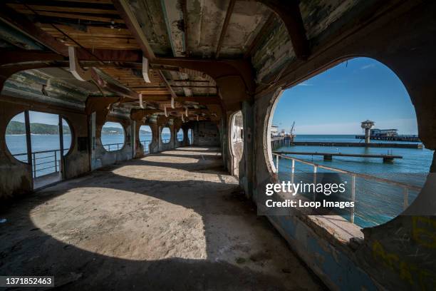 The interior of an abandoned but formerly lavish dance club and cafe from the Soviet era stretches out as a pier on the Black Sea in the war affected...