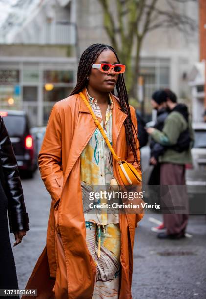 Guest is seen wearing Fendi bag, suede brown coat, button shirt & pants with print outside 16Arlington during London Fashion Week February 2022 on...