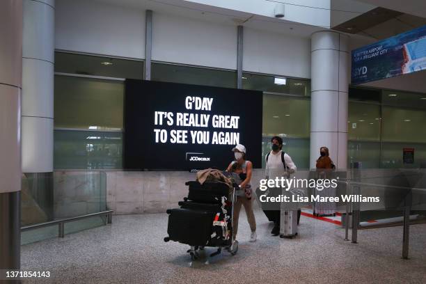 Passengers arrive at Sydney Airport on February 21, 2022 in Sydney, Australia. Australia is welcoming fully-vaccinated international travellers for...