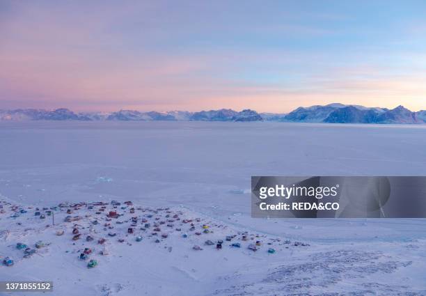Settlement Qaarsut near Uummannaq during winter in northern Westgreenland beyond the arctic circle. North America. Greenland. Danish territory.