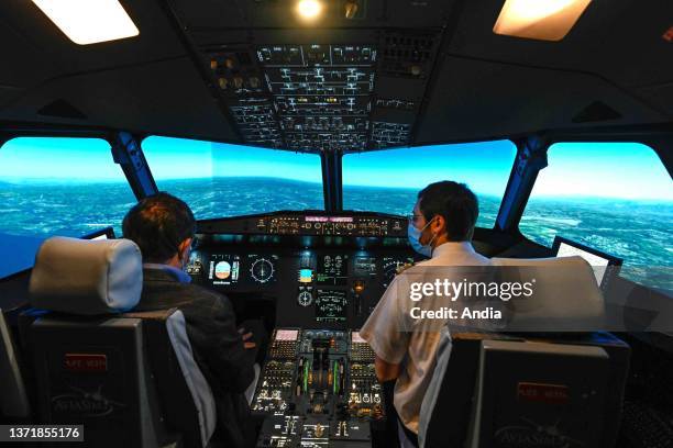 Villeurbanne : Airbus flight simulator in the premises of AviaSim. Pilot using the controllers in the cockpit.