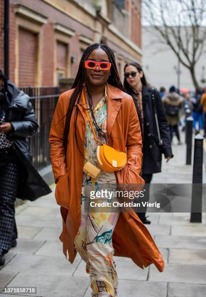Guest is seen wearing Fendi bag, suede brown coat, button shirt & pants with print outside 16Arlington during London Fashion Week February 2022 on...
