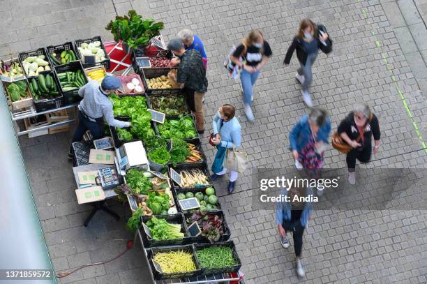 Nantes : market stall with fruits and vegetables in a pedestrian street in the city center, 'rue Guepin' street.