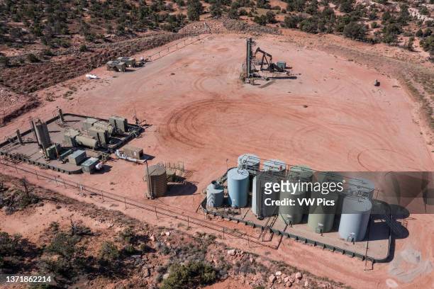 An oil well location with pump jacks, separating equipment and an oil storage tank battery in Utah..