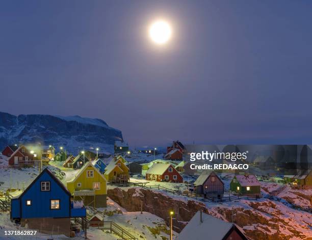 Arctic night and full moon over Uummannaq during winter in northern Westgreenland beyond the arctic circle, North America, Greenland, Danish...