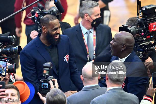 Michael Jordan and LeBron James interact after the presentation of the NBA 75th Anniversary Team during the 2022 NBA All-Star Game at Rocket Mortgage...