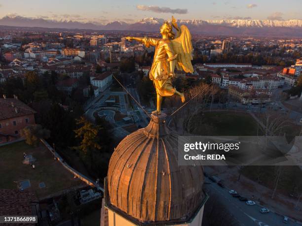 Golden angel overlooking the Castle of Udine at sunset, Udine, Friuli Venezia Giulia, Italy, Europe.