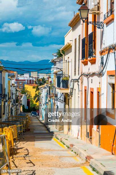Seaside resort along the Mediterranean Sea, Alicante Province. Lane in the town and colorful facades of houses.