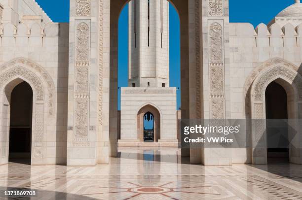 View through an archway in Sultan Qaboos Grand Mosque. Sultan Qaboos Grand Mosque, Muscat, Oman..