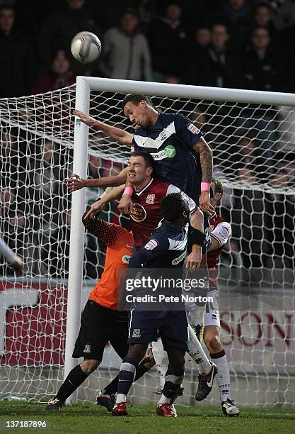 Liam Dickinson of Southend United rises above Kelvin Langmead of Northampton Town to head the ball clear during the npower League Two match between...