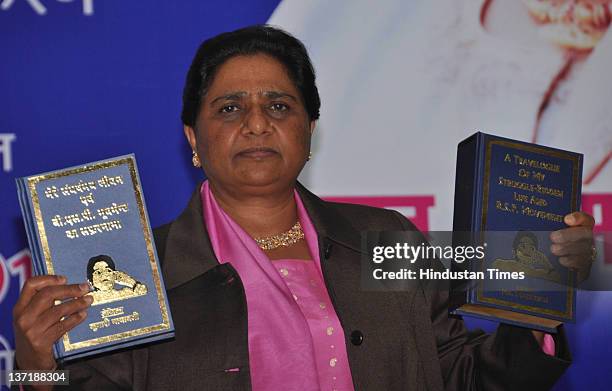 Uttar Pradesh Chief Minister Mayawati holds her memoirs in Hindi and English language on her 56th birthday at BSP Party office on January 15, 2012 in...