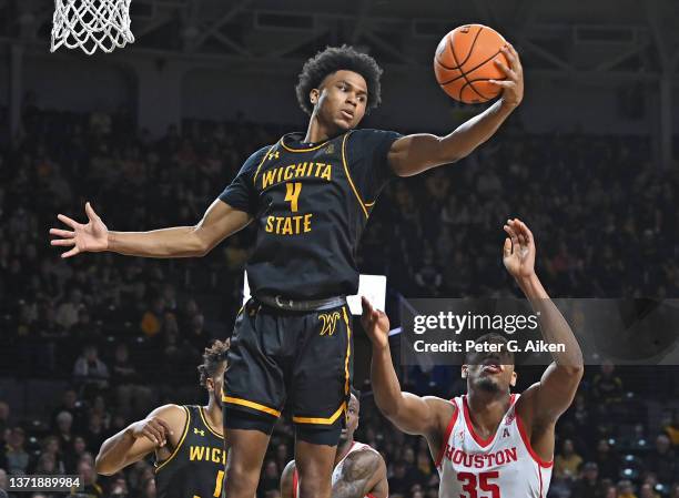 Ricky Council IV of the Wichita State Shockers grabs a rebound over Fabian White Jr. #35 of the Houston Cougars, during the second half at Charles...