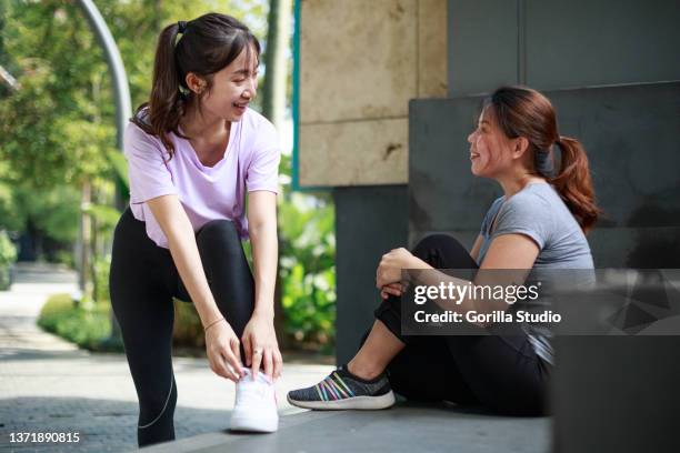 two asian women get ready for outdoor exercise - first girlfriend stock pictures, royalty-free photos & images