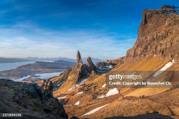 a perfect view of sunrise with a man over old man of storr, isle of skye, scotland - stock photo - isle of man stock pictures, royalty-free photos & images