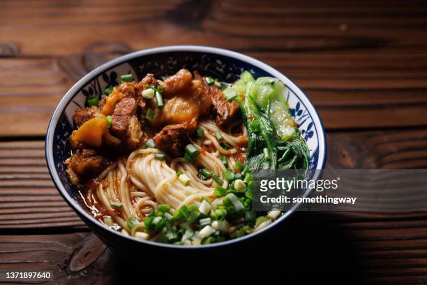 asian noodles in broth with slow cooked beef  on the wooden table - bowl of ramen stock pictures, royalty-free photos & images