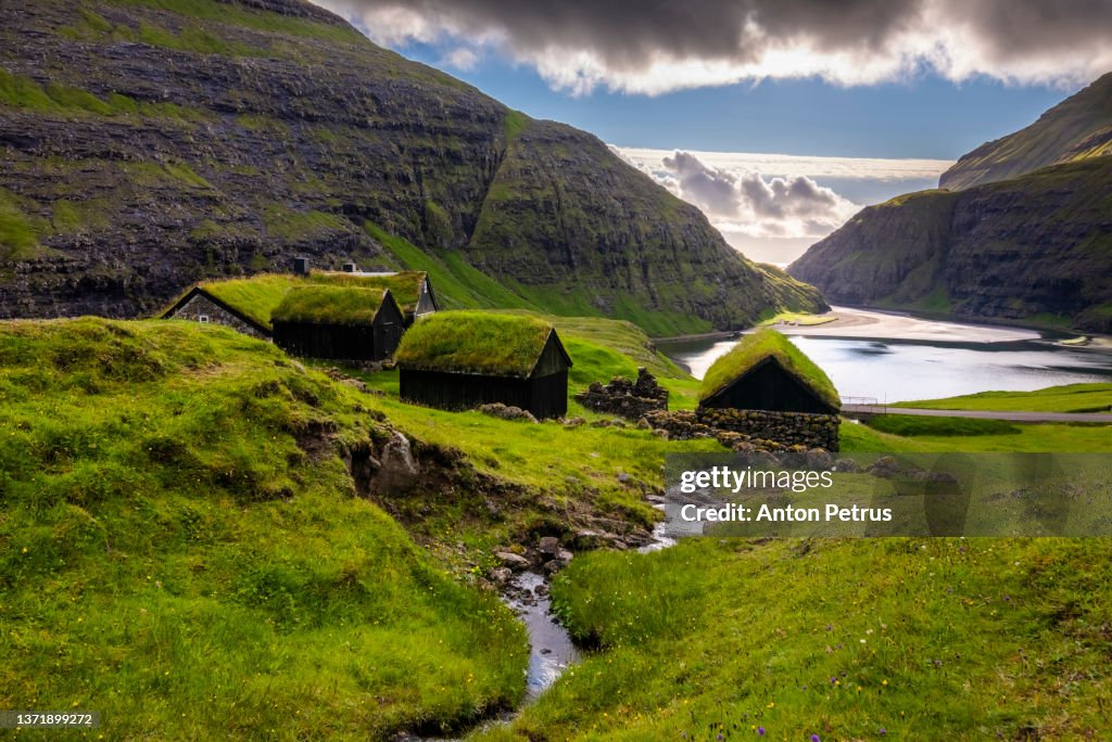 Sunset at Saksun valley with iconic green roof houses. Stremnoy island, Faroe Islands, Denmark.