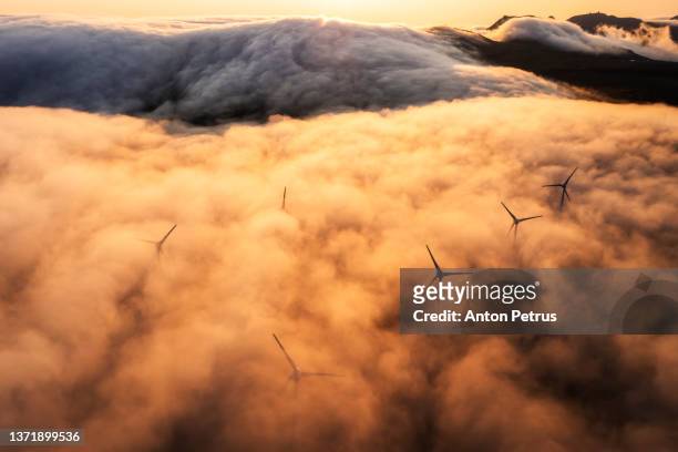 aerial view of wind turbines in the mountains. faroe islands - aspas fotografías e imágenes de stock