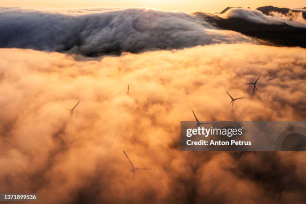aerial view of wind turbines in the mountains. faroe islands - carbon footprint stock pictures, royalty-free photos & images