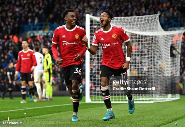 Fred celebrates with Anthony Elanga of Manchester United after scoring their team's third goal during the Premier League match between Leeds United...