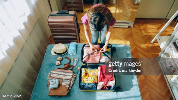 woman packing suitcase for travel - leaving apartment stock pictures, royalty-free photos & images