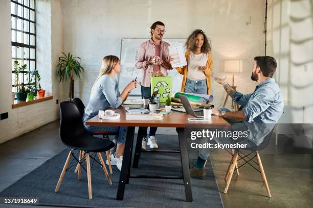 happy team of environmentalists having a meeting at casual office. - sustainable office bildbanksfoton och bilder