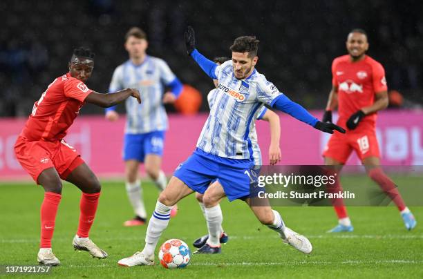 Amadou Haidara of Leipzig challenges Stevan Jovetic of Berlin during the Bundesliga match between Hertha BSC and RB Leipzig at Olympiastadion on...