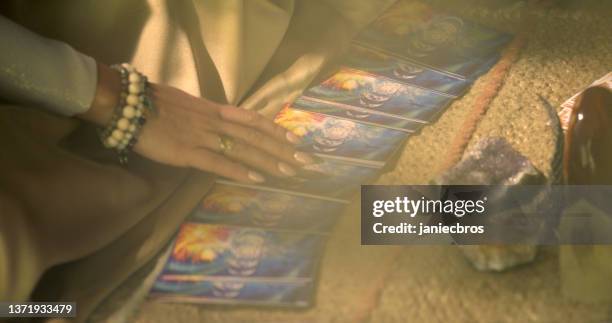 meditative space in desert tent. serene woman smudging with palo santo. soul journey with divination cards - smudging ceremony stock pictures, royalty-free photos & images