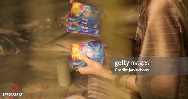 meditative space in desert tent. serene woman smudging with palo santo. soul journey with divination cards - smudging ceremony stock pictures, royalty-free photos & images