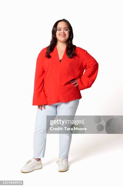 young woman with downs syndrome standing against white background - portrait young adult caucasian isolated stockfoto's en -beelden